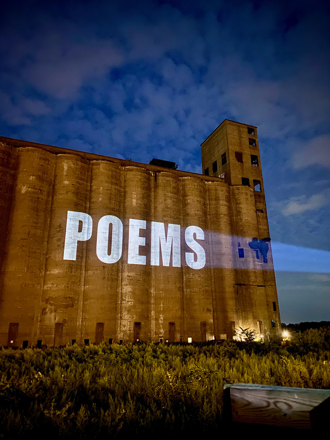 POEM projected onto the side of the Marine A Silo for the August 26, 2023 Silo City Reading Series